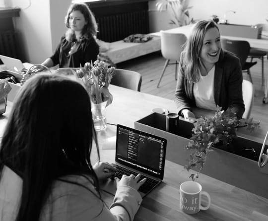 a group of women working together inside an office